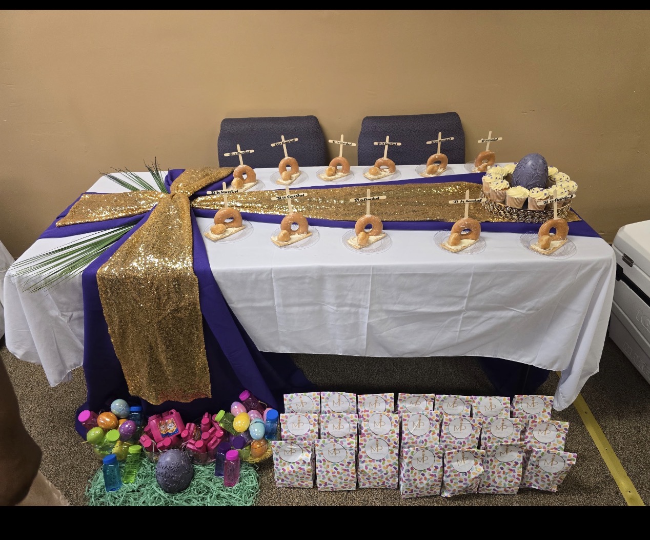 A decorated Easter fellowship table with treats and gifts