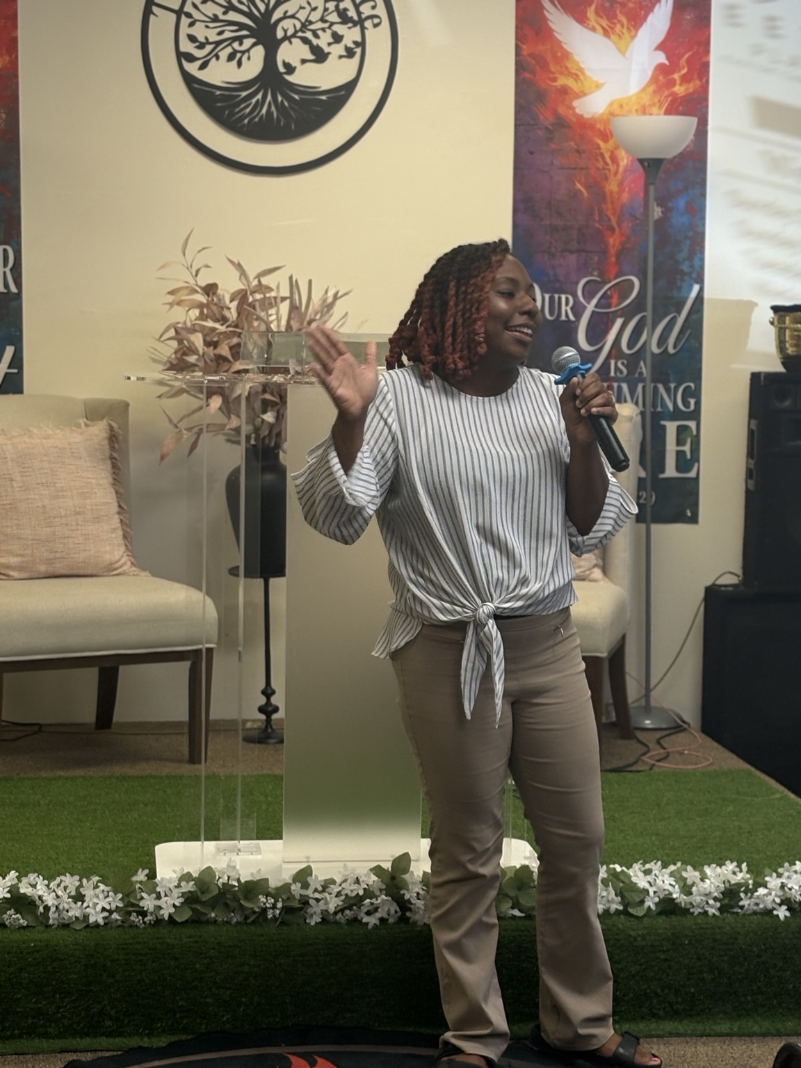 A young woman speaking into a microphone at The Meeting Place