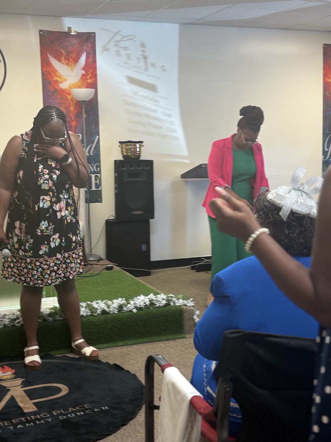 Church members sharing a moment of prayer during service