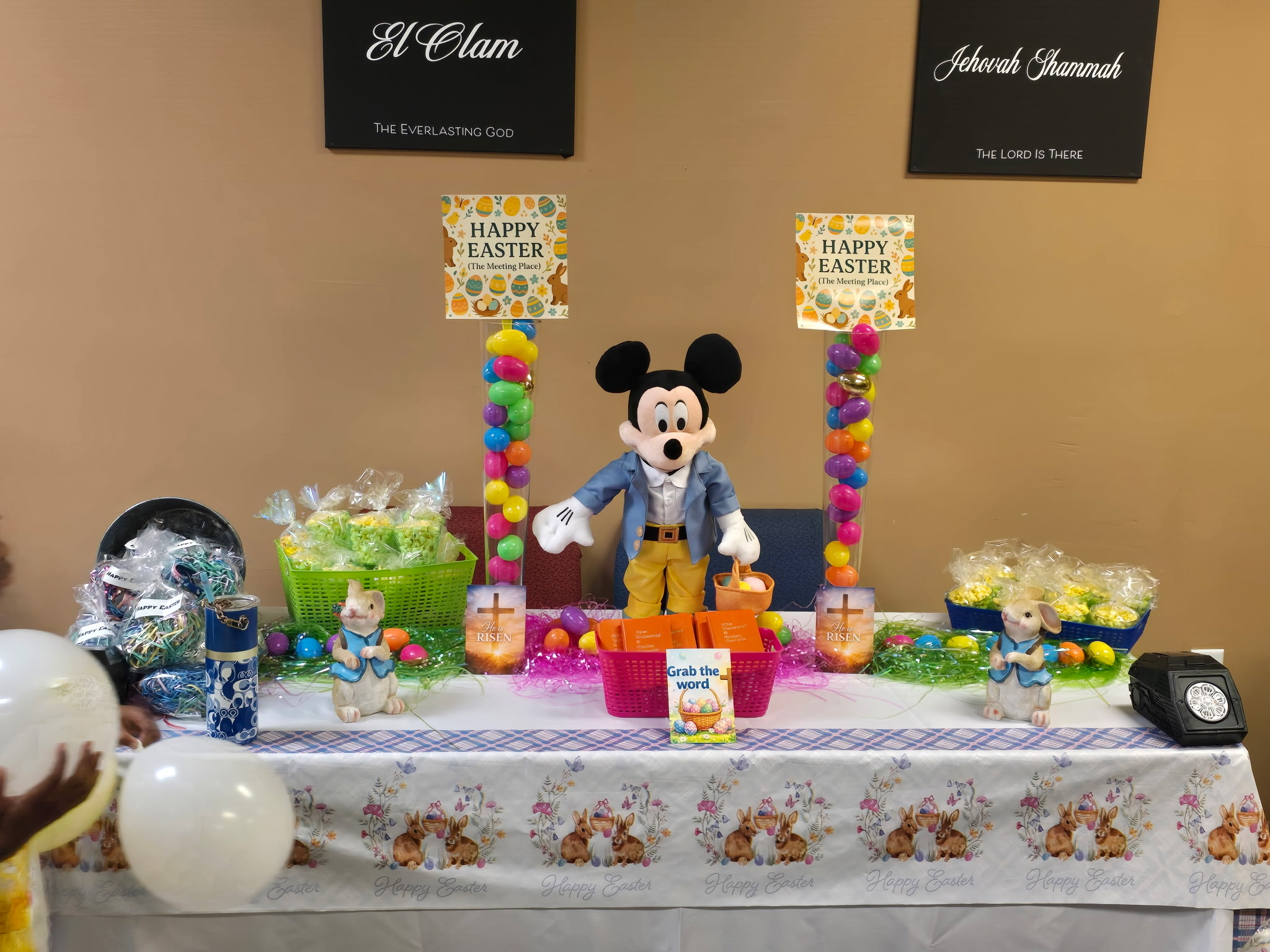 Easter outreach table with treats, scripture gifts, and children's activities